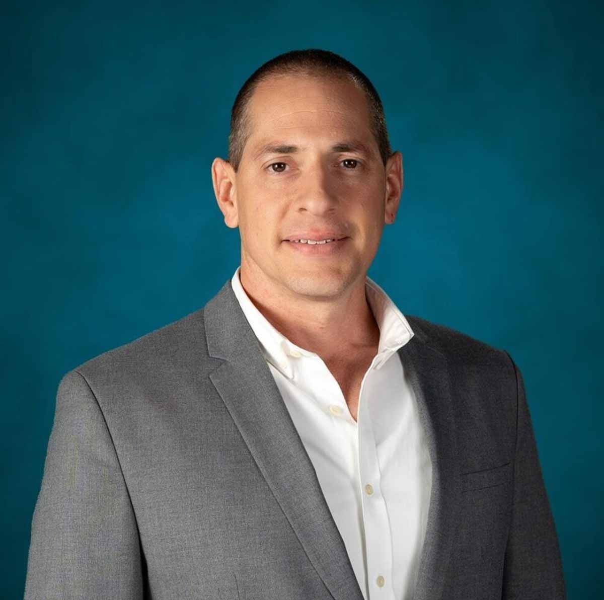 ד"ר אסף גסטפרוינד שמאי מקרקעין ועורך דין. תמונת פספורט. חולצה לבנה וג'קט אפור.