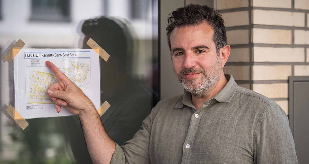 אדם מצביע על מפה עם שם הרחוב החדש על שם רמת גן