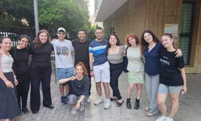 תלמידי בית הספר הדרך עם בוגרי מרכז פלא והמדריכה קורין אפל, בתמונה קבוצתית. המדריכה כורעת במרכז התמונה.